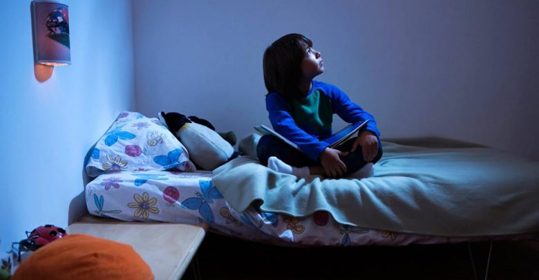 child sits on bed 780x405 1
